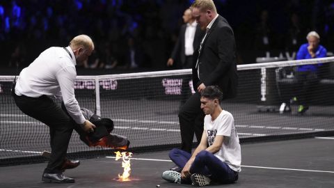 A protester lit a fire on the court at the Laver Cup at the O2 Arena in London on Friday.