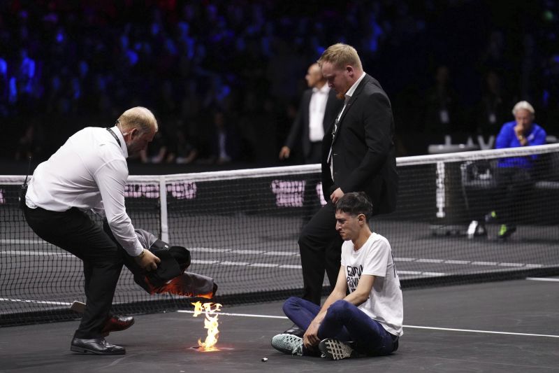 Protester sets arm on fire during Laver Cup tennis match ahead of Federer’s farewell | CNN