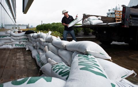 Francis Bruhm placed sandbags in front of the Nova Scotia Power building in Halifax on Friday.