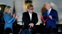 President Joe Biden presents Elton John with the National Humanities Medal after a concert on the South Lawn of the White House in Washington, Friday, Sept. 23, 2022, as first lady Jill Biden watches. 