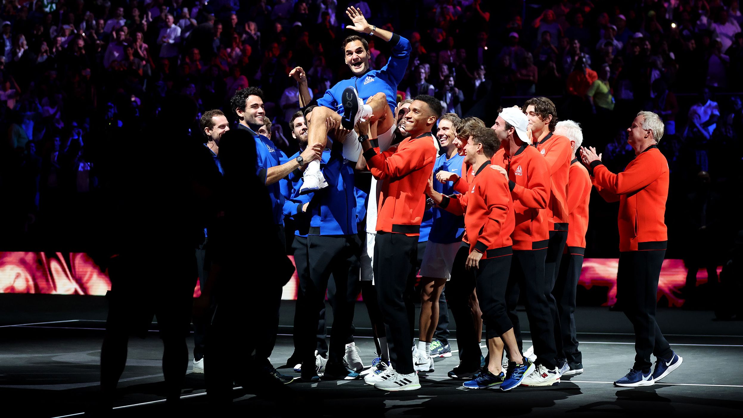 Federer is lifted into the air by his fellow players after competing in his final match.