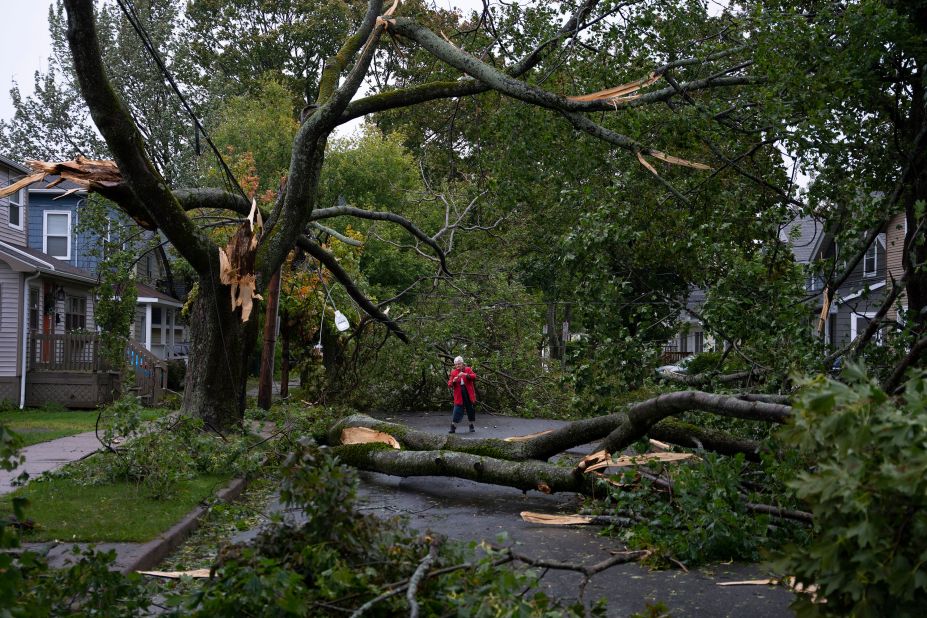 Georgina Scott surveys the damage on her street in Halifax on Saturday.