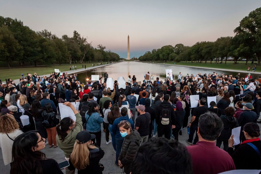 Hundreds of people attended a candlelight vigil at sunset  for Mahsa Amini at the Lincoln Memorial Reflecting Pool in Washington on September 23.