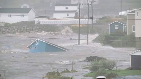 Water surrounds a collapsed home in Channel-Port aux Basque, Newfoundland, on Saturday. 