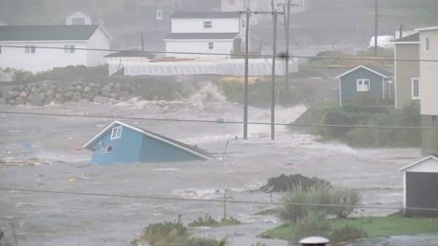 A collapsed house was surrounded by water on Saturday in Channel-Port aux Basque, Newfoundland. 