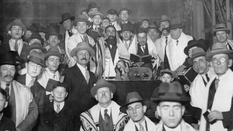 A rabbi and his community celebrating the Jewish New Year Rosh Hashanah in a synagogue around 1925.