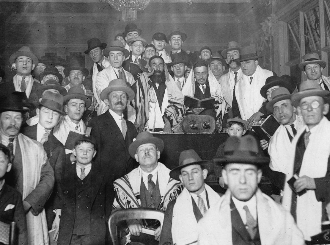 A rabbi and his community celebrating the Jewish New Year Rosh Hashanah in a synagogue around 1925.