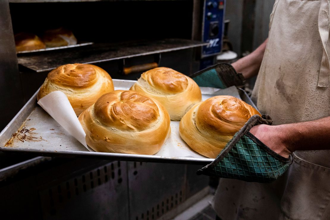 David Rosenberg pulls challah from the oven at Roling's Bakery in Elkins Park, Pennsylvania on September 6, 2021. The bakery sells hundreds of loaves of challah for Rosh Hashanah each year. 
