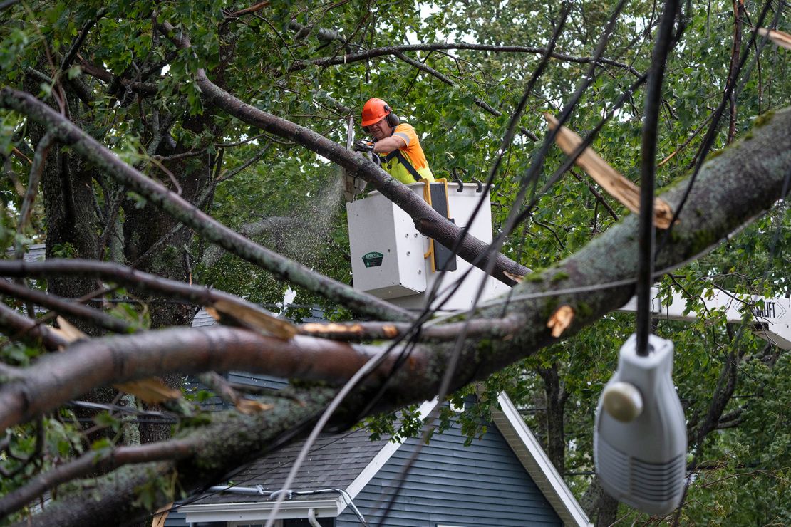 A worker clears fallen trees and downed wires from damage in Halifax on September 24, 2022.  