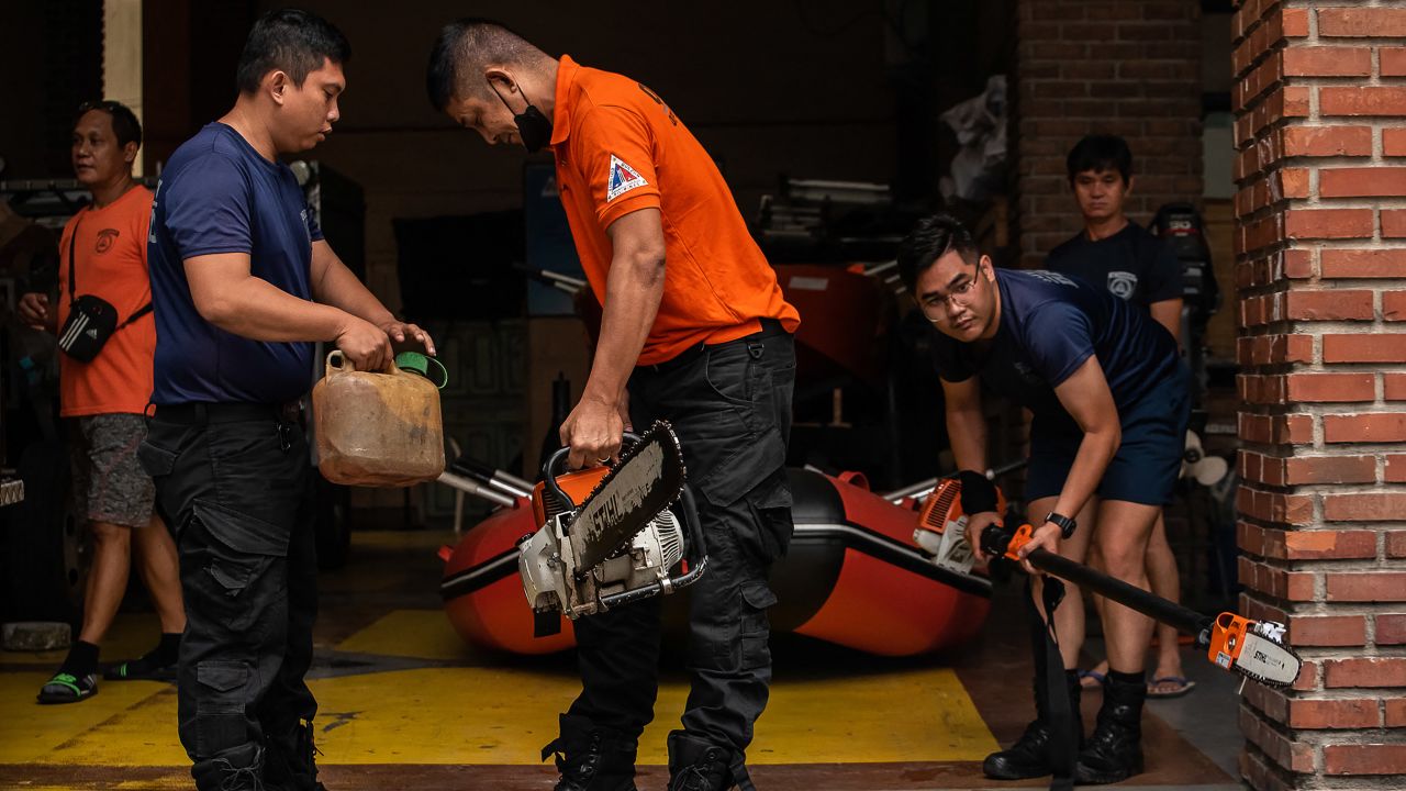 Members of the Disaster Risk Reduction and Management Office in Quezon City, Manila, prepare rubber boats and life vests ahead of Typhoon Noru making landfall on Sunday.