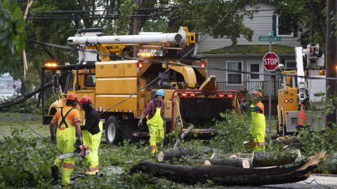 Workers clear fallen trees and downed wires from damage caused by post tropical storm Fiona in Halifax on Saturday, Sept. 24, 2022.