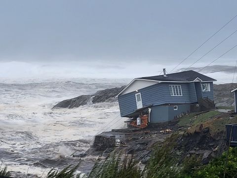 A home fights against high winds caused by post-tropical cyclone Fiona in Port aux Basques, Newfoundland and Labrador on Saturday, Sept. 24, 2022. The home has since been lost at sea.