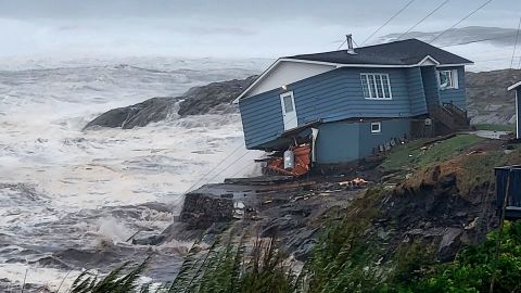 A home fights against high winds caused by post Tropical Storm Fiona in Port aux Basques, Newfoundland and Labrador on Saturday.