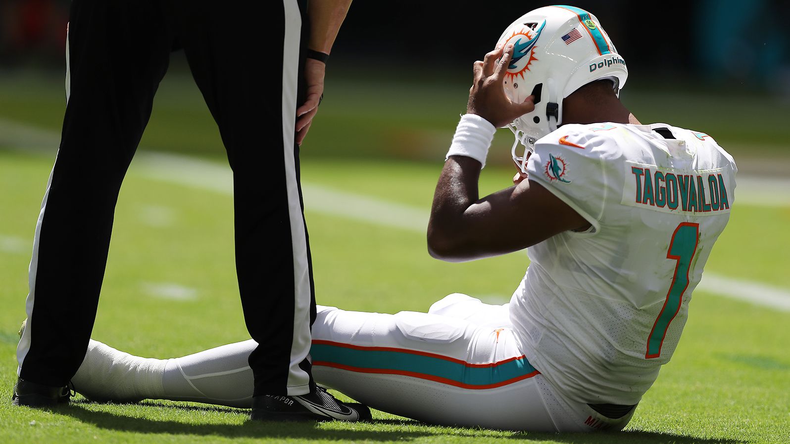 Dolphins QB Tua Tagovailoa sits on the turf in the second quarter of Miami's game against the Buffalo Bills. Tagovailoa was tackled by Matt Milano and his head hit the ground, causing the Miami man to be taken into the locker room to be evaluated for a concussion. He eventually came back to lead the Dolphins to victory, but the <a href="index.php?page=&url=https%3A%2F%2Fedition.cnn.com%2F2022%2F09%2F26%2Fsport%2Ftua-tagovailoa-miami-dolphins-buffalo-bills-spt-intl%2Findex.html" target="_blank">NFLPA is initiating a review of the injury and medical evaluation.</a>