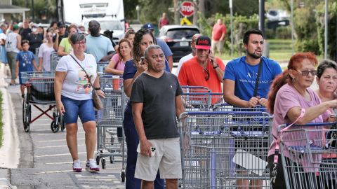 Shoppers wait in line outside a retail warehouse as people rush to prepare for Tropical Storm Ian, in Kissimmee, Florida, on September 25, 2022.