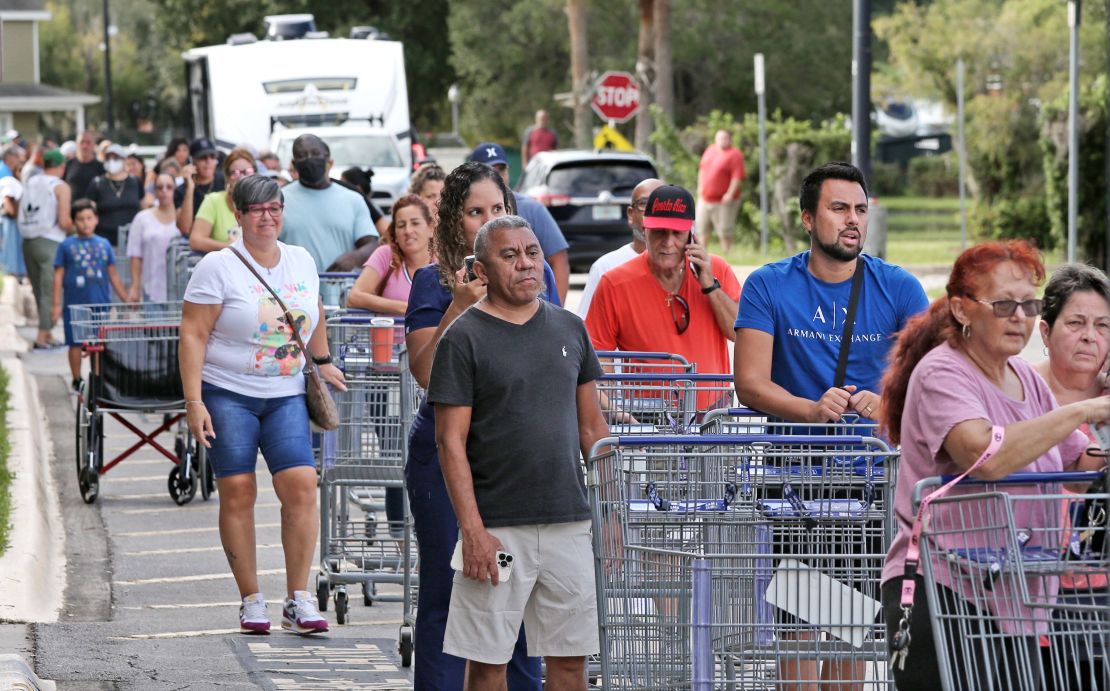 Shoppers wait in line Sunday as people rush to prepare for Ian in Kissimmee, Florida. 
