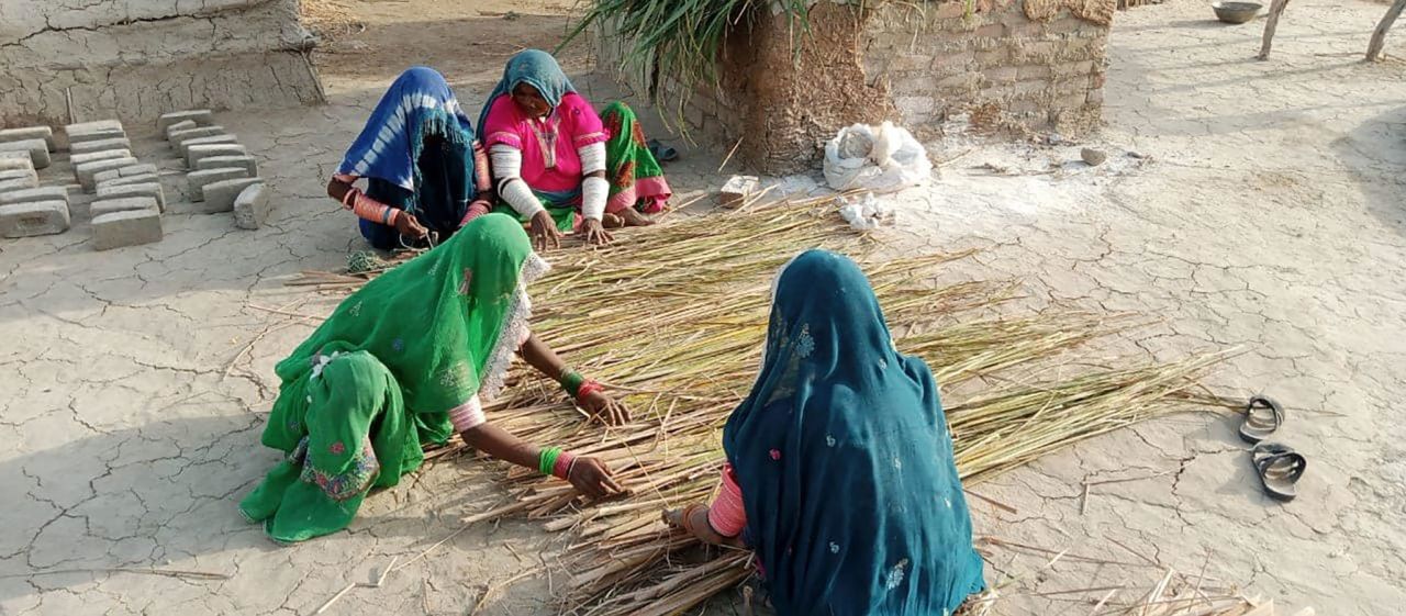 Women making matting for the bamboo shelters.
