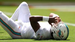 MIAMI GARDENS, FLORIDA - SEPTEMBER 25: Quarterback Tua Tagovailoa #1 of the Miami Dolphins lays on the turf during the second quarter of the game against the Buffalo Bills at Hard Rock Stadium on September 25, 2022 in Miami Gardens, Florida. (Photo by Megan Briggs/Getty Images)