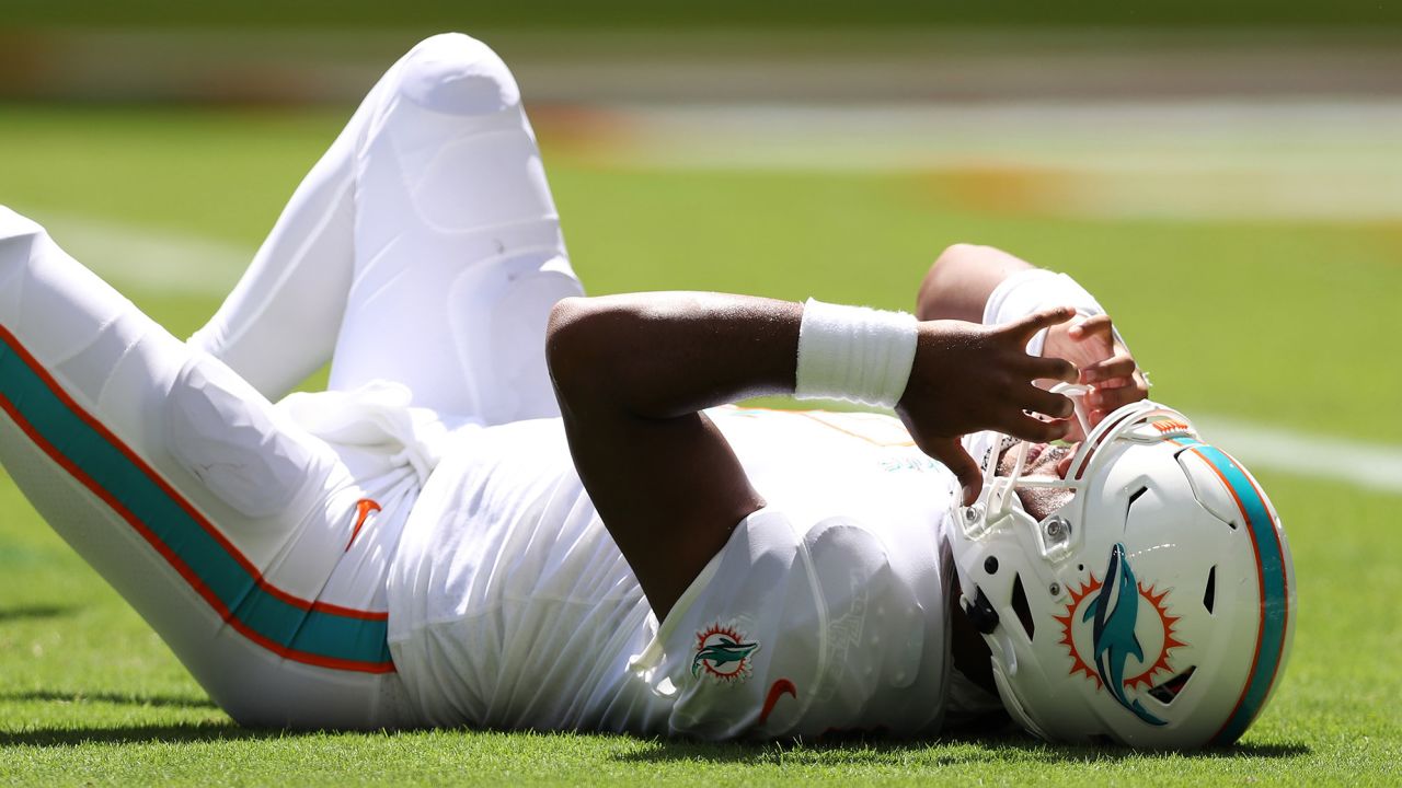 The Miami Dolphins' Tua Tagovailoa lays on the turf during a game against the Buffalo Bills on September 25, 2022.