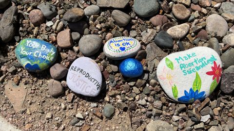 Painted stones outside the clinic offer support for women seeking medical services there.