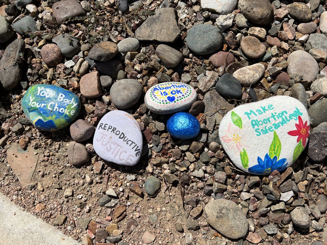 Painted stones outside the clinic offer support for women seeking medical services there.