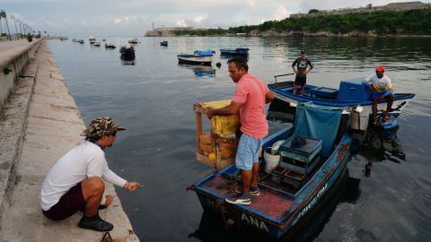 Fishermen prepare to move their boats in Havana, Cuba, on Monday before the arrival of Hurricane Ian.