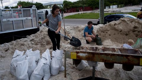Fort Myers resident Sarah Peterson fills sand bags Saturday in anticipation of Hurricane Ian.
