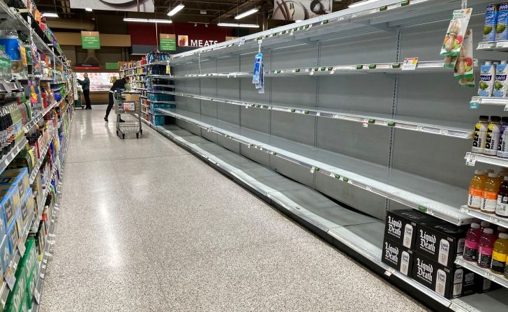 Shelves are empty in a supermarket's water aisle in Kissimmee on Monday.
