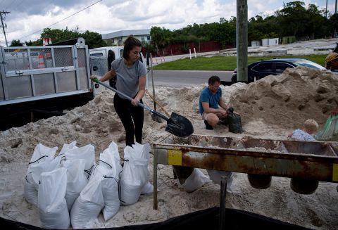 Sarah Peterson loads up sandbags at Fort Myers Beach in Florida on Saturday, September 24.