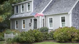 CHATHAM, CAPE COD:  American flag flying and traditional wooden timber clapboard architecture house near Cockle Cove at Chatham, Cape Cod, New England, United States.  (Photo by Tim Graham/Getty Images)