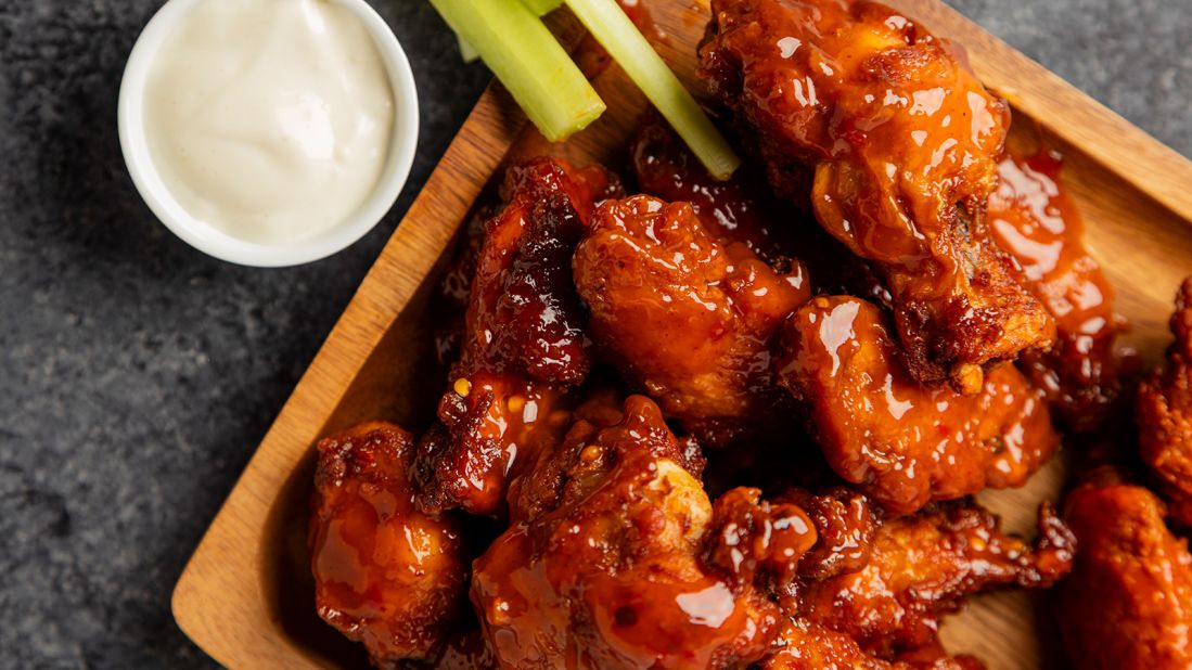 <strong>Chicken wings, United States:</strong> Spicy buffalo chicken wings served with a pile of celery sticks and a ramekin of dunking sauce -- traditionally blue cheese dip, but ranch works, too -- are a sports bar staple.