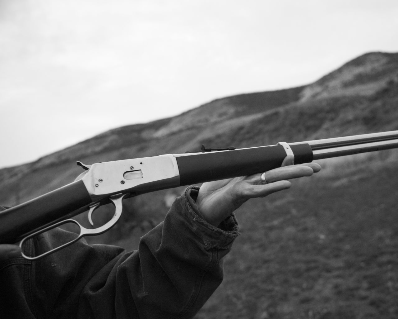 Photographed while out coyote hunting, local resident Jarad shows Horvath his gun.