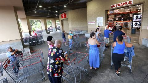 Shoppers wait in line to enter the Costco store in Altamonte Springs, Fla., north of Orlando, Monday, Sept. 26, 2022.