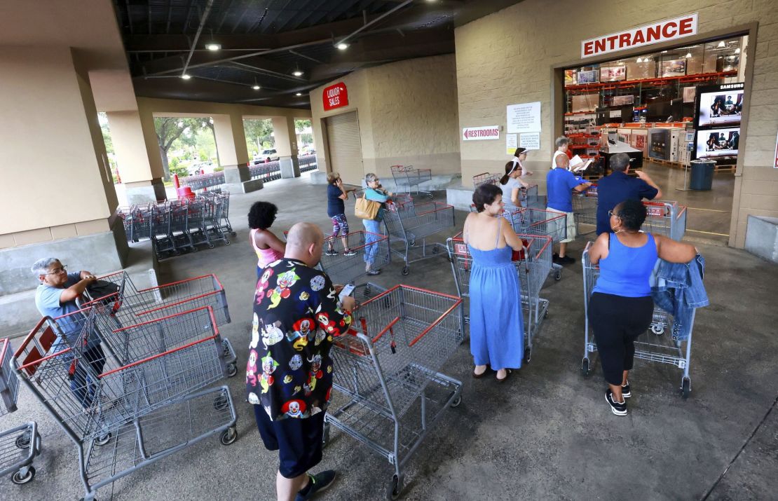 Shoppers wait in line to enter the Costco store in Altamonte Springs, Fla., north of Orlando, Monday, Sept. 26, 2022.
