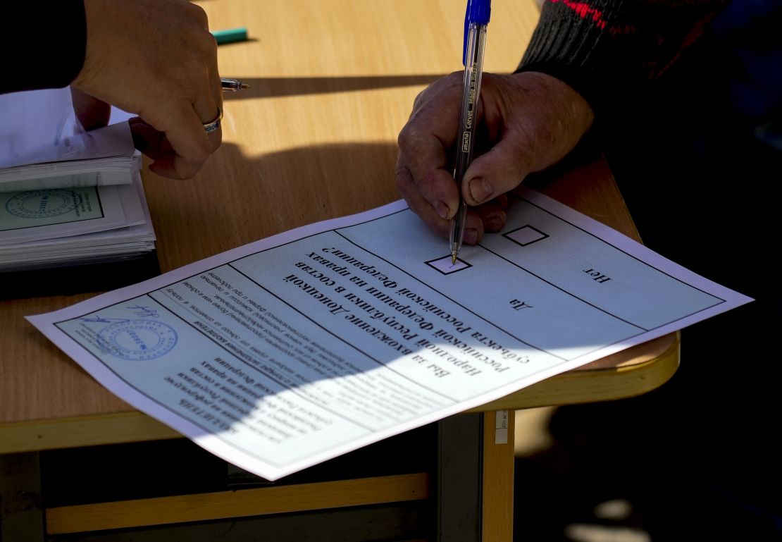 People cast their votes in controversial referendums in the Donetsk region of Ukraine on Sunday.