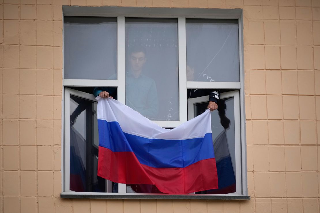 A Russian flag is displayed at the Pedagogical University in Ukraine's eastern region of Luhansk, which is controlled by Russia-backed separatists on Tuesday.