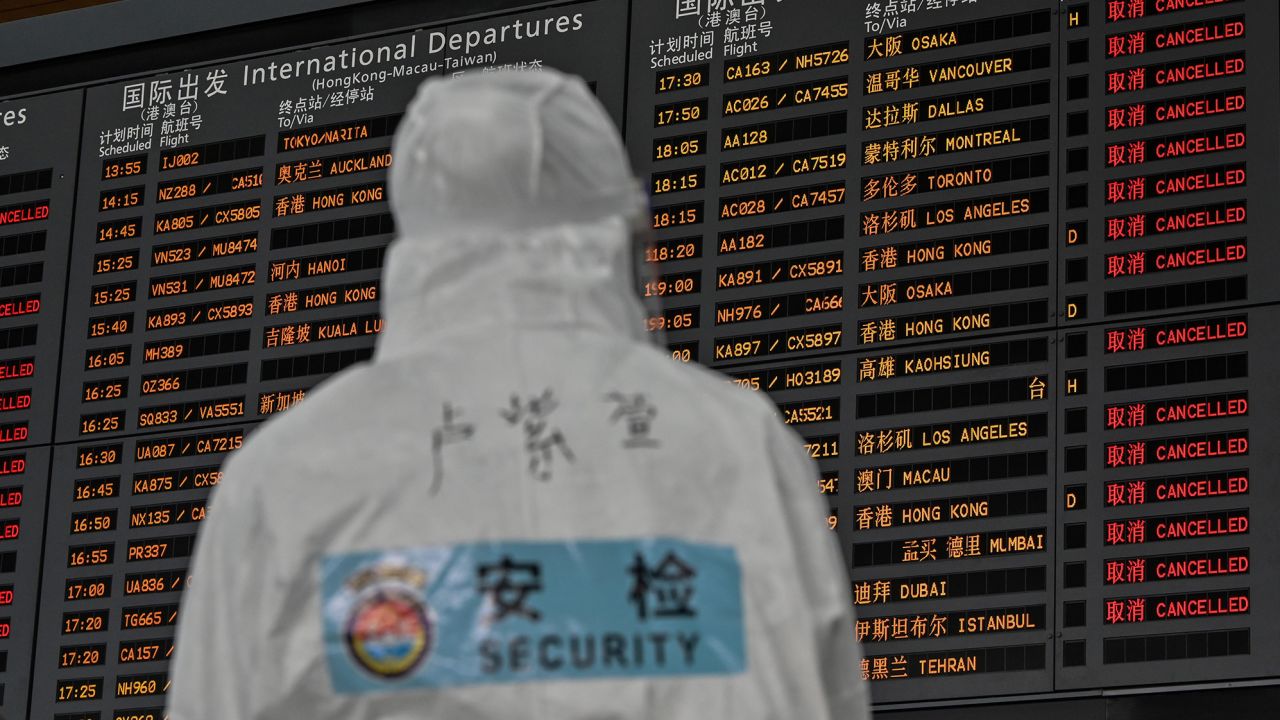 An airport security worker wearing protective gear at Shanghai Pudong International Airport in March 2020, amid Covid-19 fears. 