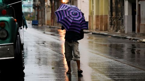 A man walks down a street in Havana, Cuba, on Tuesday during the passage of Hurricane Ian.