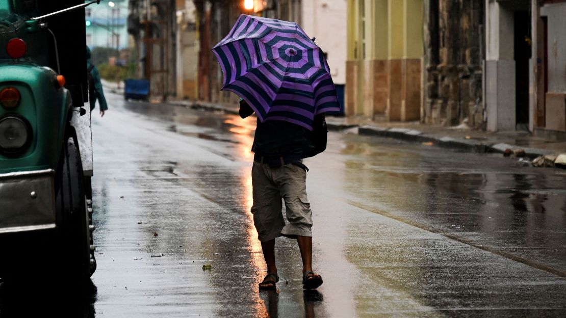 A man walks down a street in Havana, Cuba, on Tuesday during Hurricane Ian.