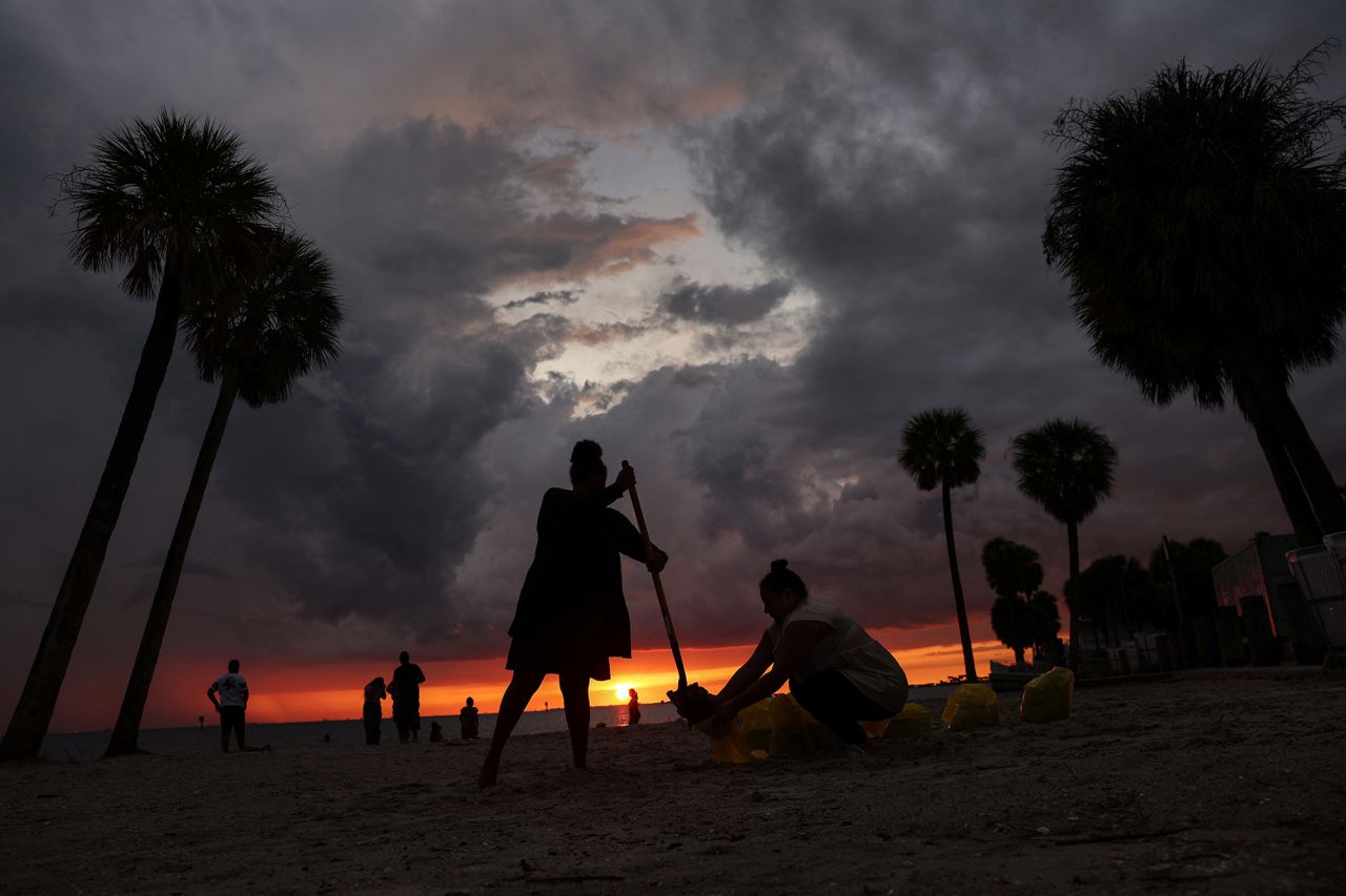 Local residents fill sandbags at Ben T. Davis Beach in Tampa on Monday.