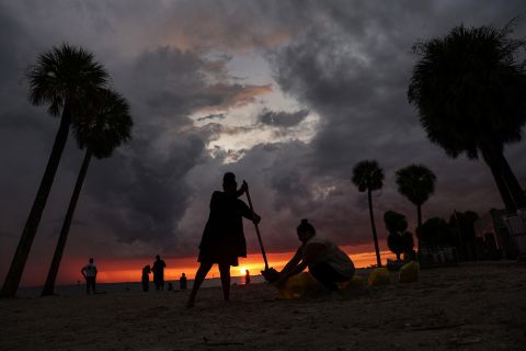 Local residents fill sandbags in Tampa on Monday to help protect their homes from flooding.