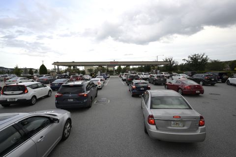 People wait in lines to fuel their vehicles at a Costco Wholesale store in preparation for Ian's arrival in Orlando, Florida.