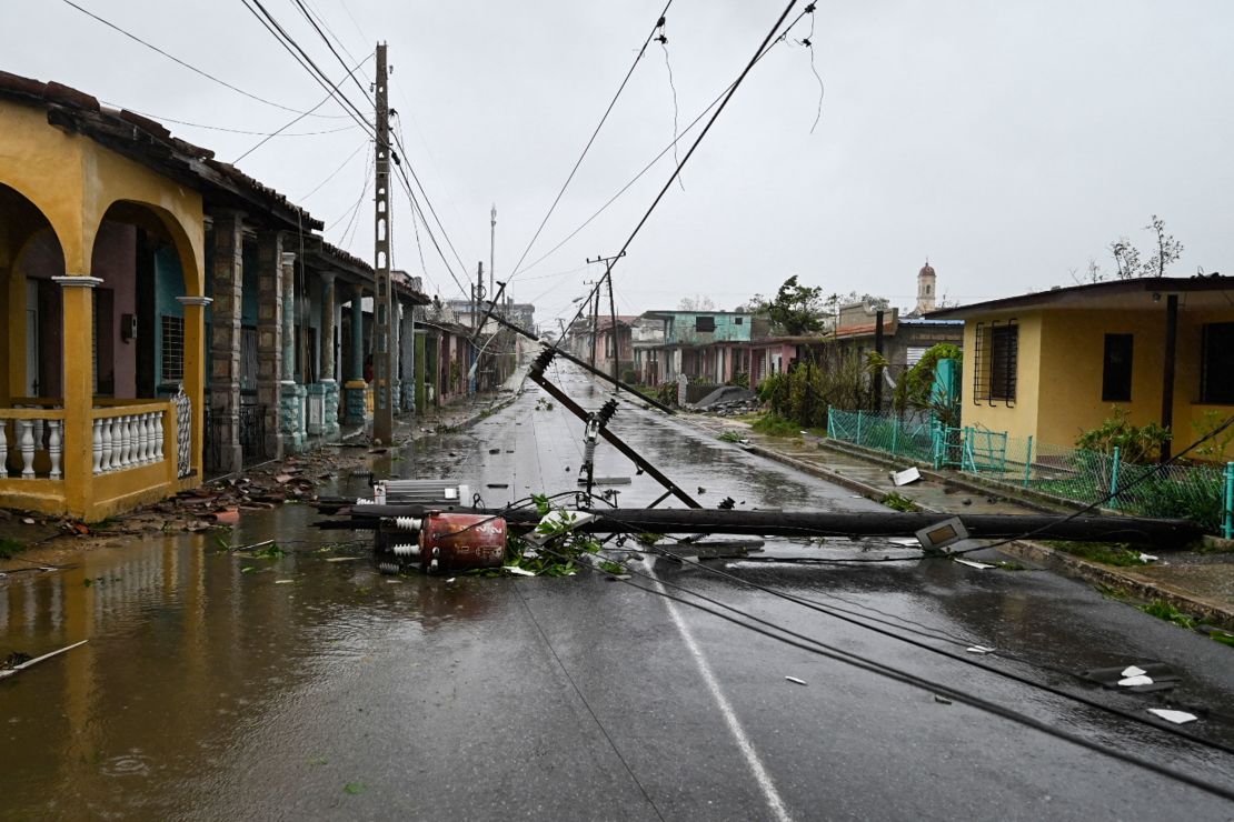 A utility pole lies on the street in Consolacion del Sur, Cuba, on Tuesday as Hurricane Ian passes.