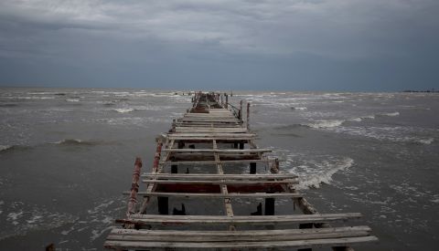 Waves kick up under a dark sky along the shore of Batabano, Cuba, as <a rel=