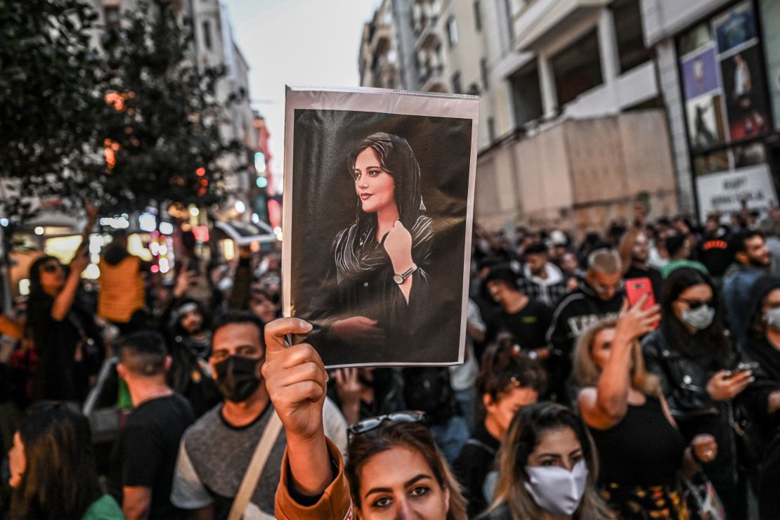 A protester holds a portrait of Mahsa Amini during a demonstration in Tehran. 