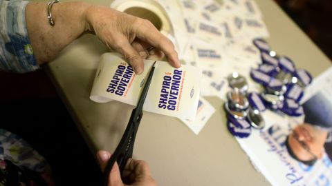 A supporter cuts campaign stickers for attendees at a Northampton County meet & greet event for Pennsylvania Democratic gubernatorial nominee Josh Shapiro at United Steelworkers on September 22, 2022 in Bethlehem, Pennsylvania. 