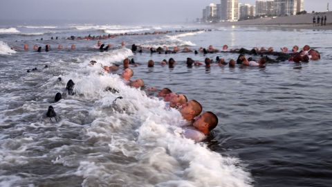 Navy SEAL candidates participate in "surf immersion" during Basic Underwater Demolition/SEAL (BUD/S) training at the Naval Special Warfare (NSW) Center in Coronado, Calif., on May 4, 2020. 