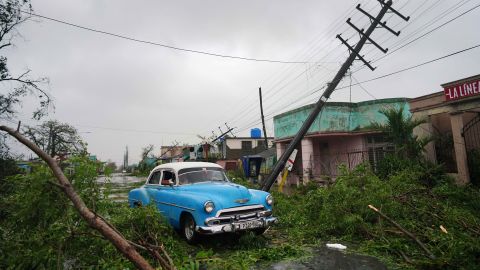 A vintage car passes by debris caused by the Hurricane Ian as it passed in Pinar del Rio, Cuba, September 27, 2022.