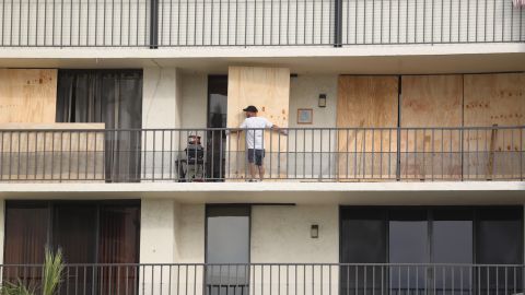 A condominium resident boards up a home located on Indian Rocks Beach in Pinellas County, Florida, to prepare for the potential impact of Hurricane Ian.
