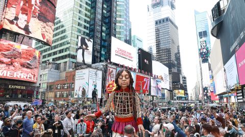 The 12-foot puppet known as Little Amal walks through Times Square as onlookers watch on September 16, 2022.